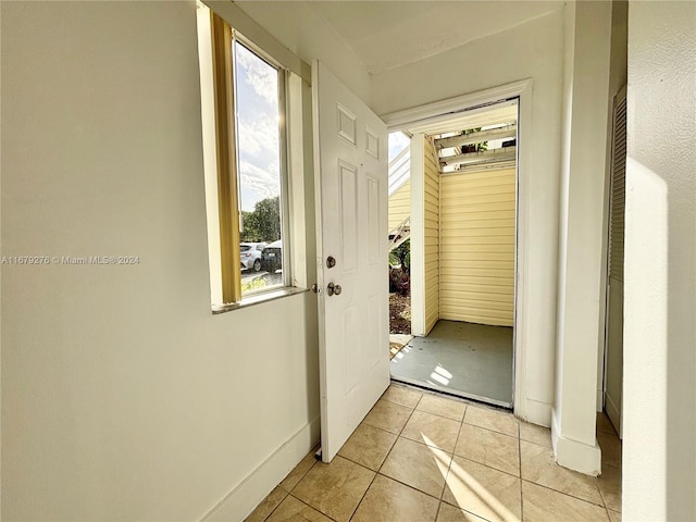 doorway to outside featuring light tile patterned floors