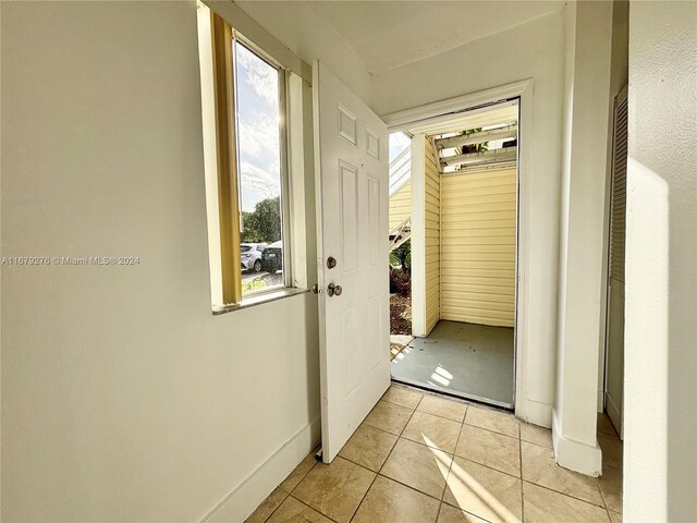 3405 NW 44th St Unit 104, Oakland Park, FL 33309 - hall with light tile patterned flooring and baseboards