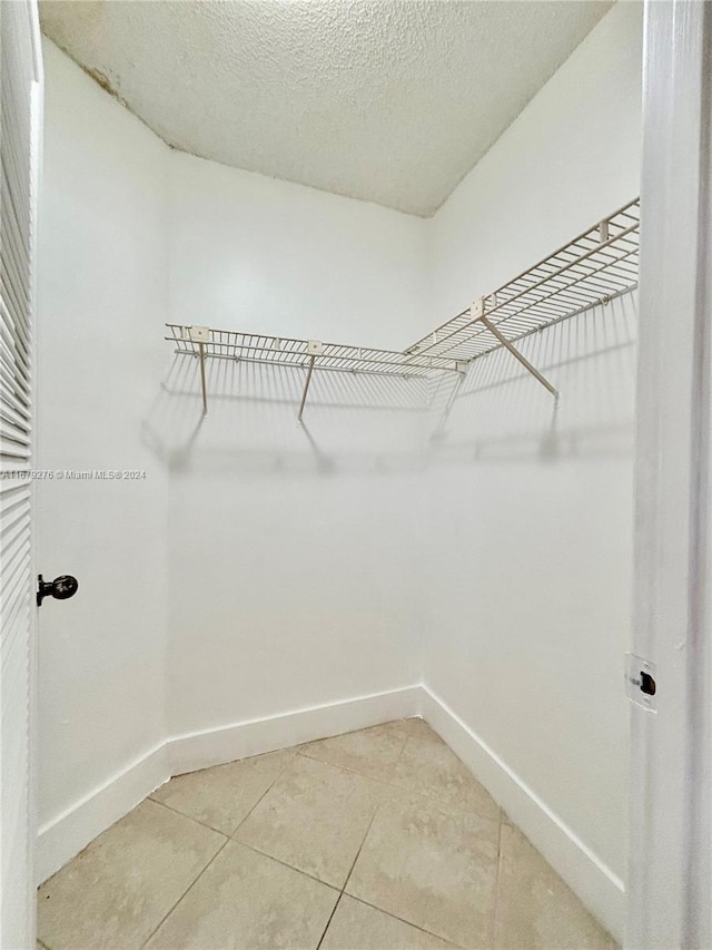 spacious closet featuring tile patterned flooring