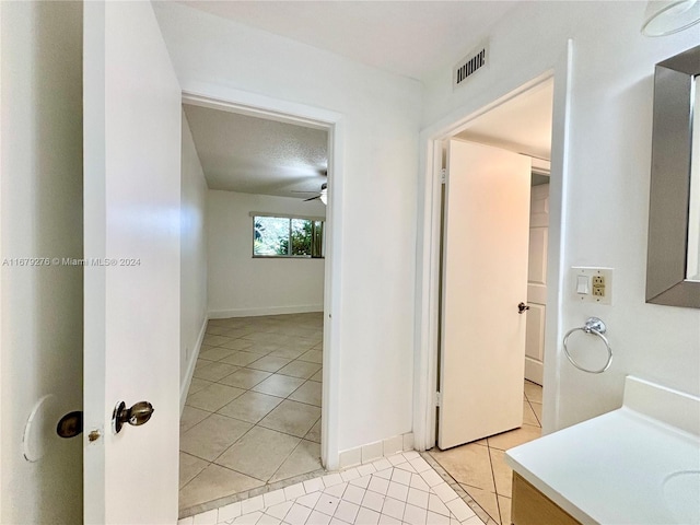 bathroom with vanity, ceiling fan, a textured ceiling, and tile patterned flooring