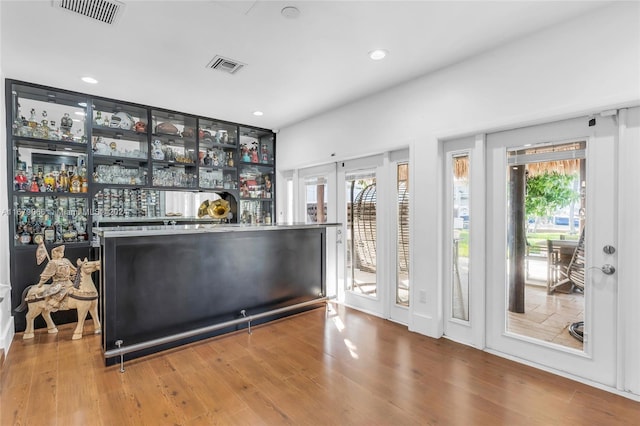 bar with hardwood / wood-style flooring