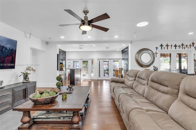 living room with french doors, ceiling fan, and light hardwood / wood-style flooring