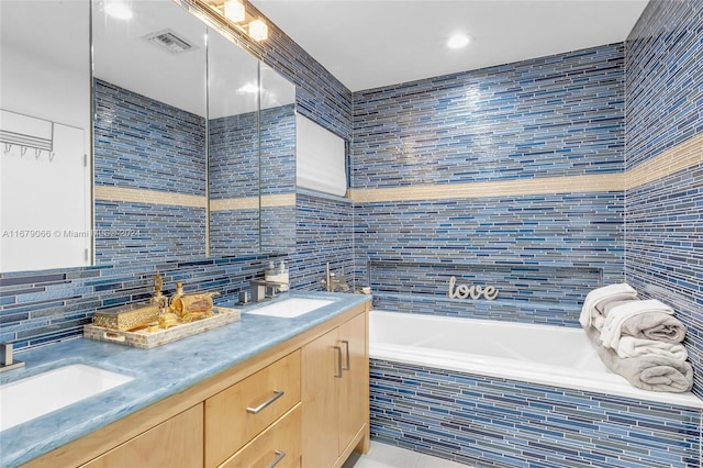 bathroom featuring tile walls, vanity, and a relaxing tiled tub