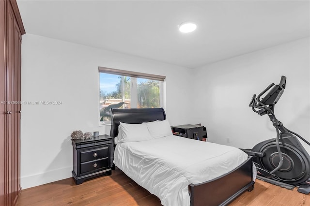 bedroom with hardwood / wood-style flooring