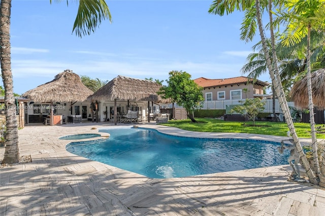 view of pool with an in ground hot tub, a patio area, a lawn, and a gazebo