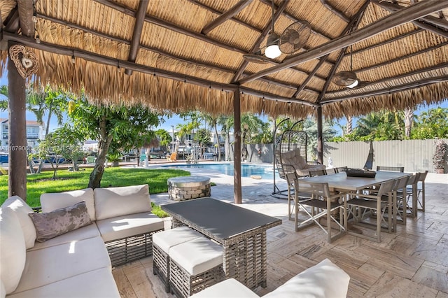 view of patio featuring a gazebo, an outdoor living space, and a fenced in pool