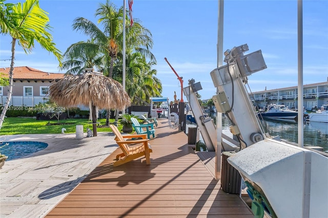 view of dock featuring central AC, a yard, and a water view