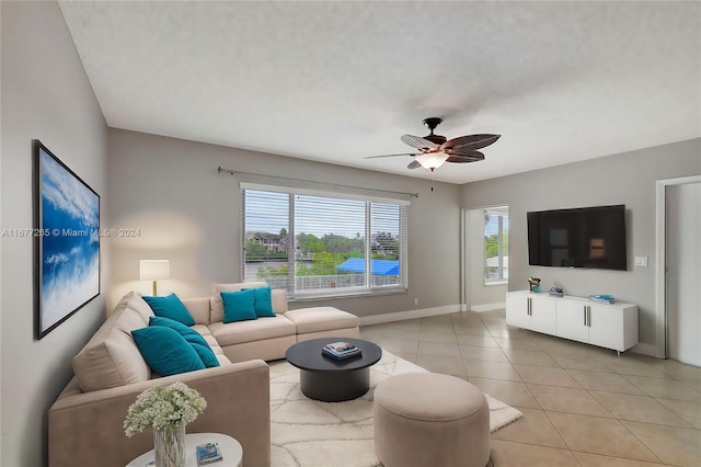 tiled living room with ceiling fan