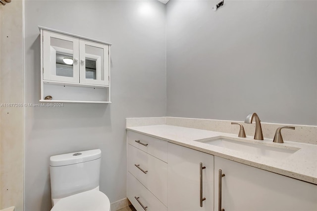 bathroom with toilet and vanity