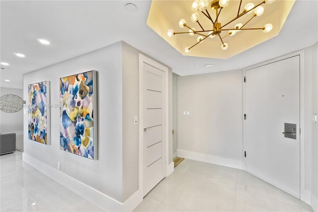 corridor featuring a notable chandelier and light tile patterned floors