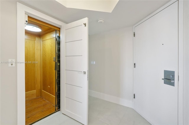 corridor with light tile patterned floors