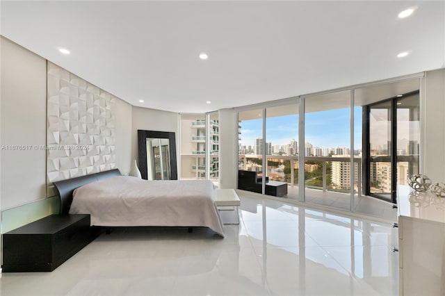 bedroom with a wall of windows, access to outside, and tile patterned flooring