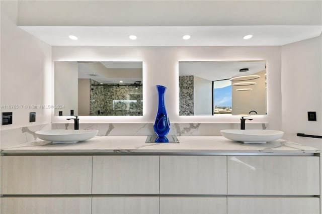 bathroom with vanity and a shower with shower door