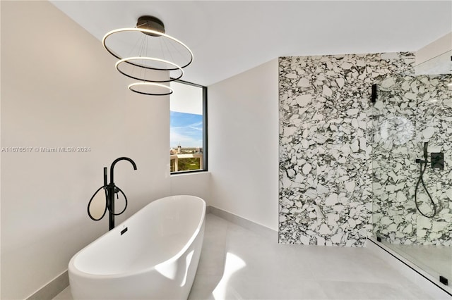 bathroom with a baseboard radiator, a chandelier, and plus walk in shower