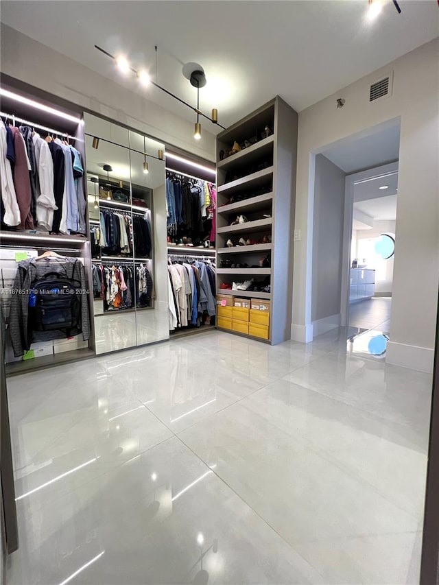 spacious closet featuring tile patterned floors