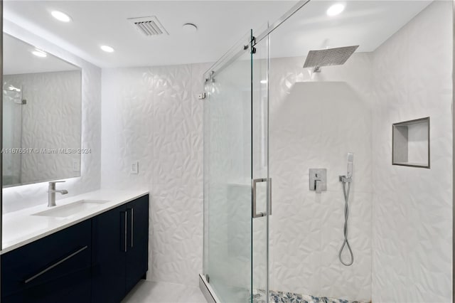 bathroom with vanity and an enclosed shower