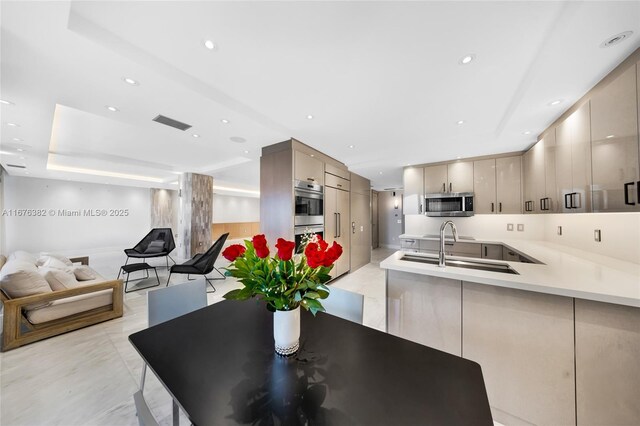 dining room with a raised ceiling and sink