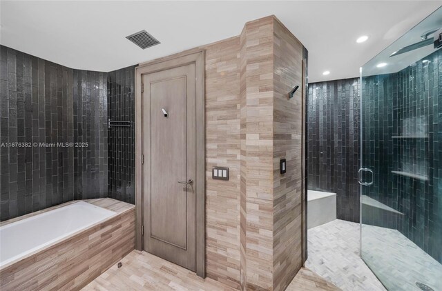 bathroom featuring plus walk in shower