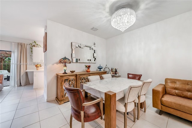 dining area with light tile patterned floors, baseboards, visible vents, and a chandelier