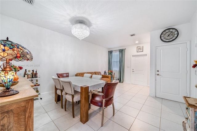 dining area featuring an inviting chandelier, light tile patterned floors, baseboards, and visible vents