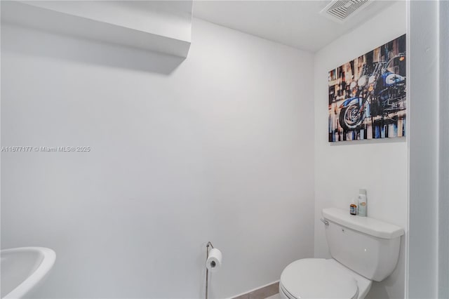 bathroom with visible vents and toilet