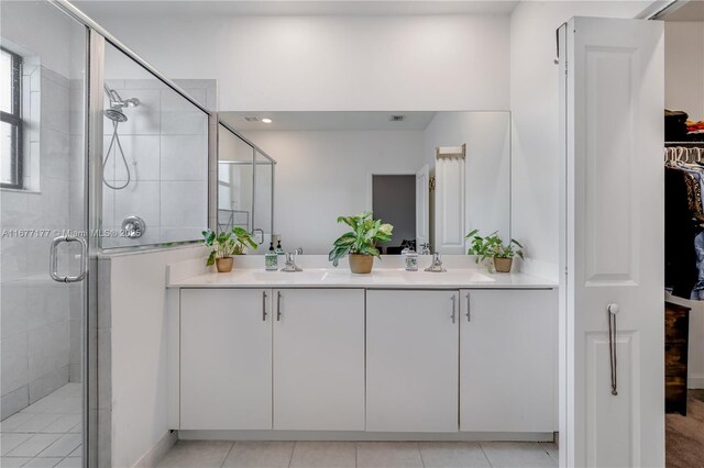 bathroom with vanity, tile patterned flooring, a shower with door, and toilet