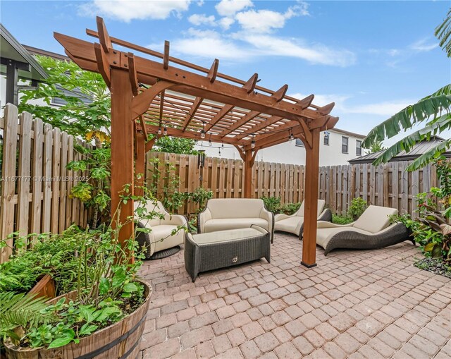 view of patio with an outdoor living space and a pergola