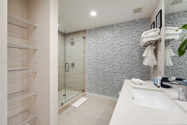 bathroom with vanity, tile patterned flooring, and an enclosed shower