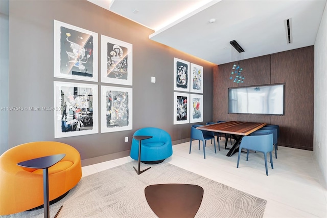 interior space with wood walls and light tile patterned floors