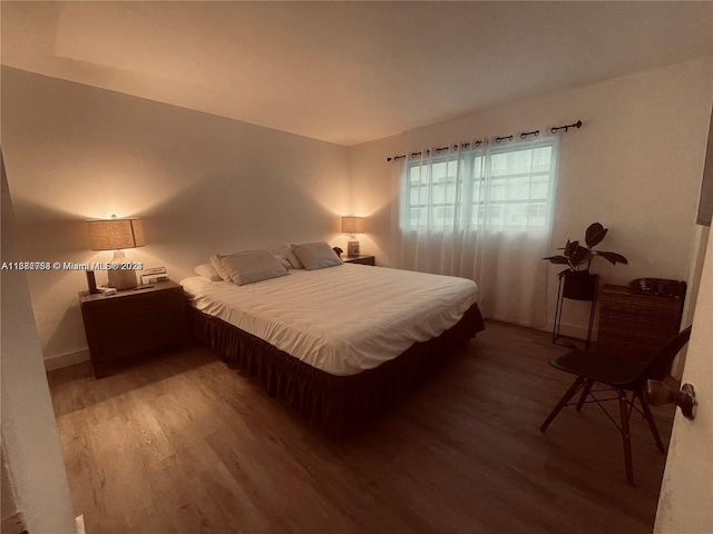 bedroom with wood-type flooring