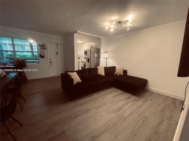 living room featuring a notable chandelier and wood-type flooring