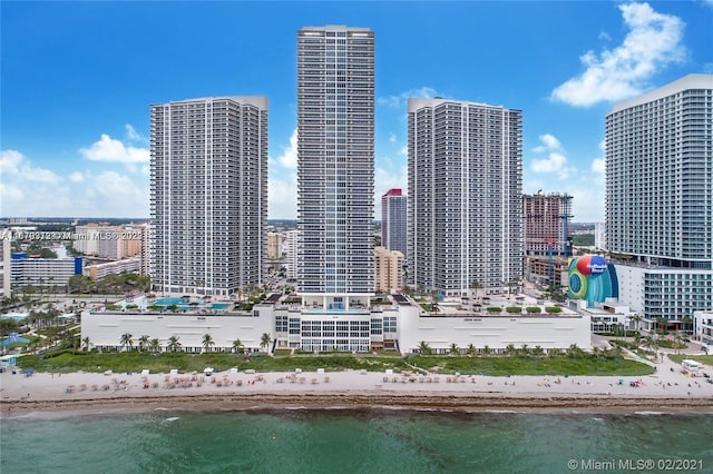 city view featuring a view of the beach and a water view