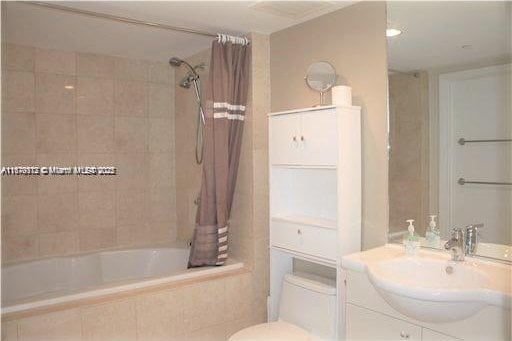 full bathroom featuring vanity, toilet, and shower / bath combo with shower curtain