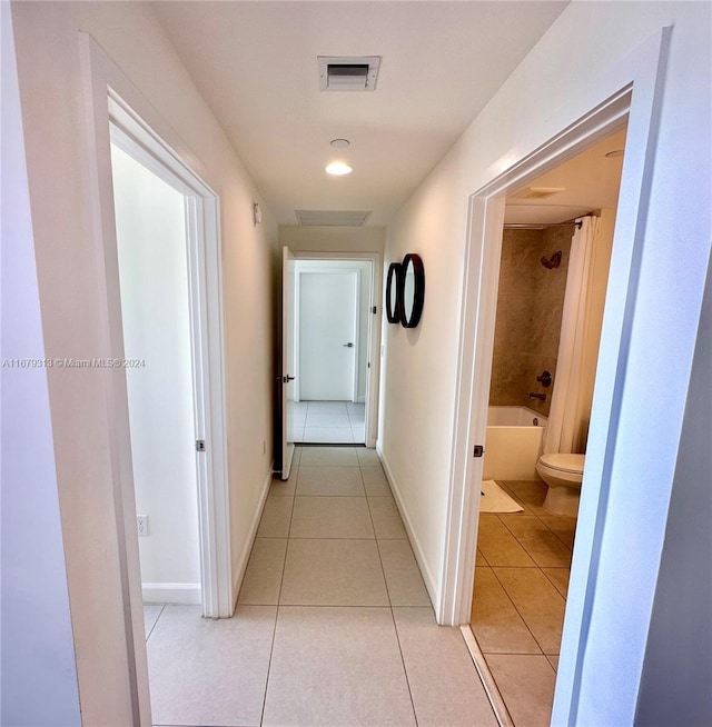 hall with light tile patterned floors