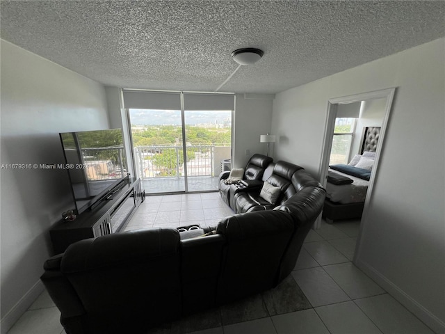 living room featuring a textured ceiling and light tile patterned floors