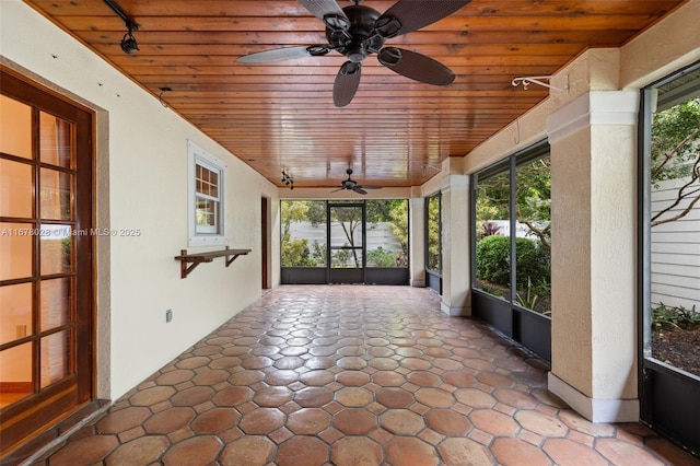 unfurnished sunroom featuring wood ceiling