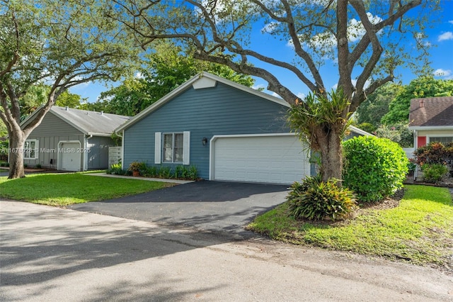 ranch-style house with a garage and a front lawn