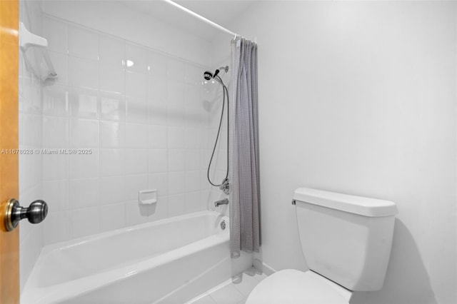 bathroom with tile patterned flooring, toilet, and shower / bath combo