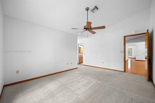 carpeted empty room with ceiling fan and vaulted ceiling