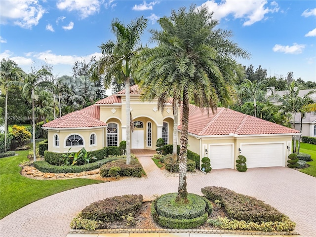 mediterranean / spanish-style home featuring french doors and a garage