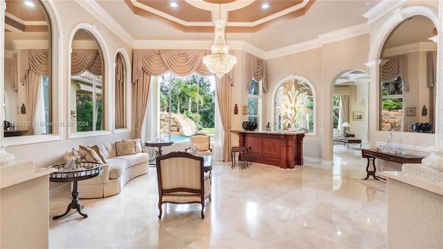 interior space with crown molding, a notable chandelier, and a towering ceiling