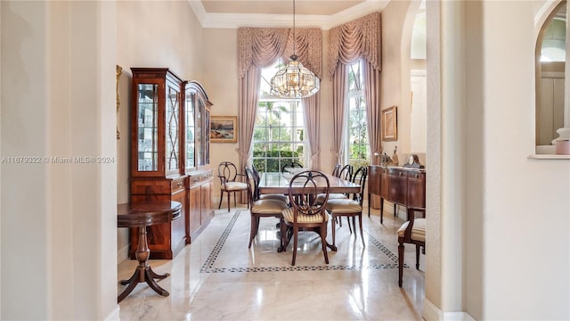 dining area featuring crown molding and a notable chandelier