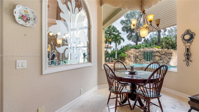 dining area featuring an inviting chandelier