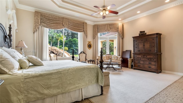 carpeted bedroom featuring ornamental molding, a raised ceiling, and ceiling fan