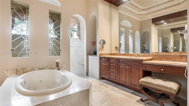 bathroom featuring vanity, tiled bath, and ornamental molding