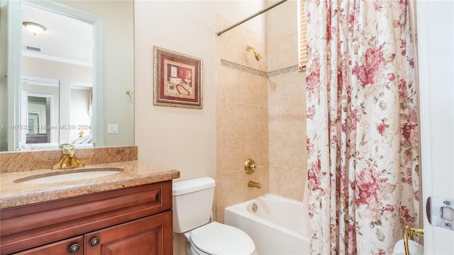 full bathroom with vanity, toilet, ornamental molding, and shower / bath combo