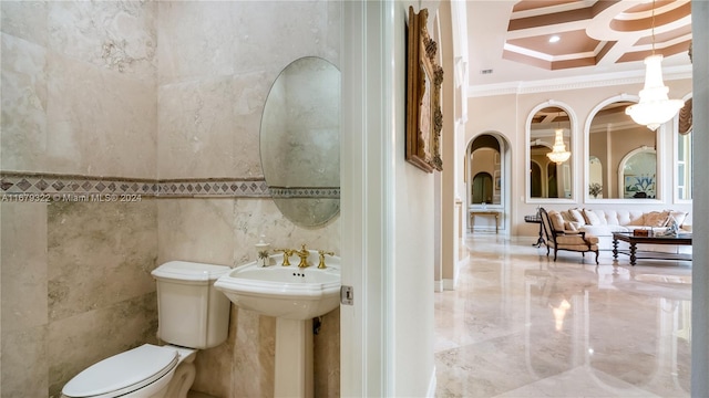 bathroom with toilet, coffered ceiling, tile walls, beamed ceiling, and crown molding