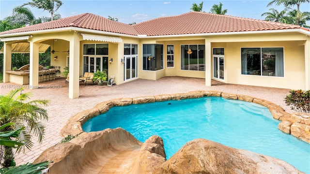 view of swimming pool featuring a patio area and ceiling fan