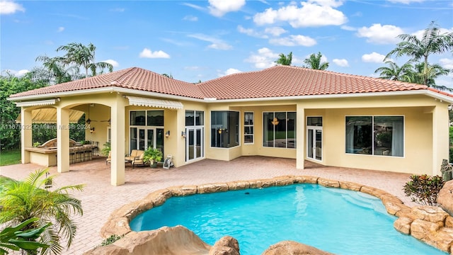 back of property with a patio area and ceiling fan