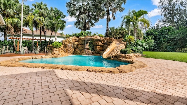 view of swimming pool with a patio and pool water feature